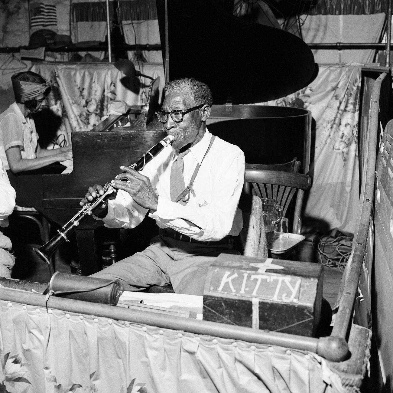 Jazz Combo Performs Under A Mural In A New Orleans Nightclub.