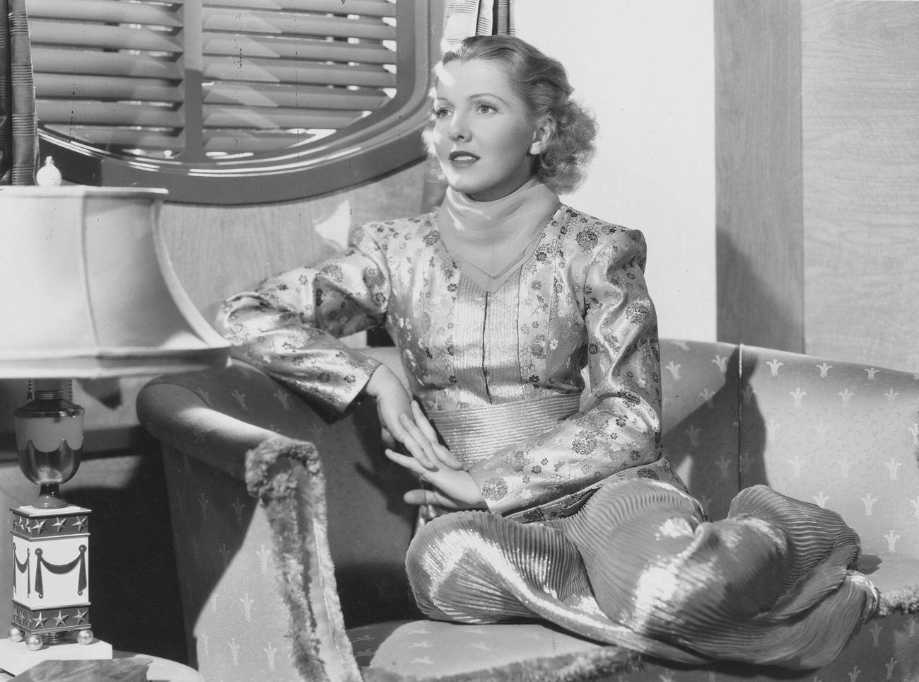 Jean Arthur Sitting In A Chair.