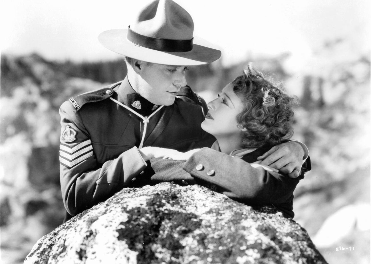 Nelson Eddy And Jeanette Macdonald Lean On A Rock, Gazing Into Each Other'S Eyes In A Scene From 'Rose Marie,' 1936.