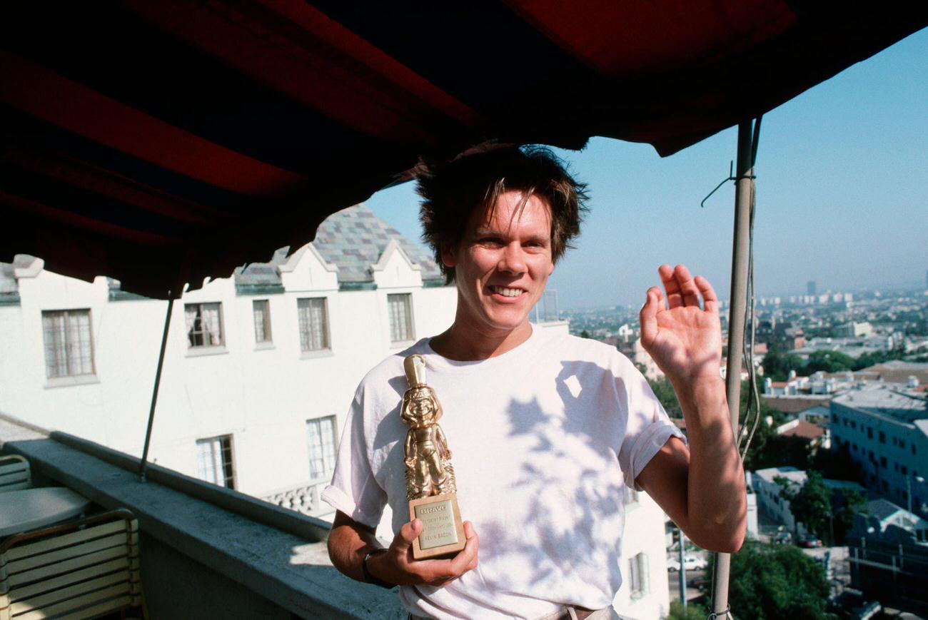 Kevin Bacon With The Bravo Award For His Acting Talents, Recognized For His Role In &Amp;Quot;Footloose&Amp;Quot;.