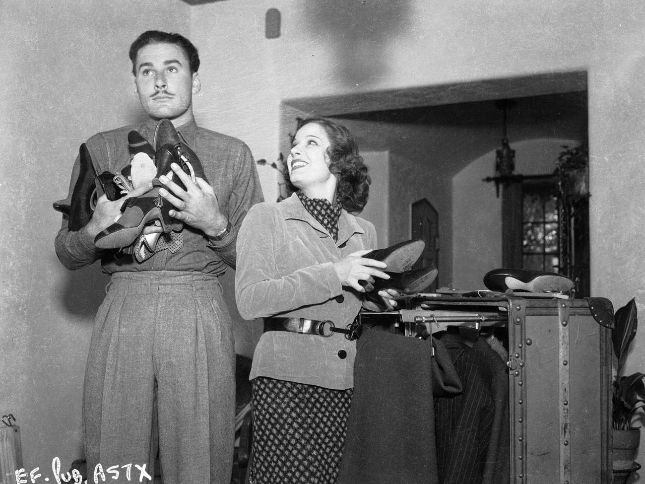 Errol Flynn And Lili Damita Sorting Shoes, Circa 1938.