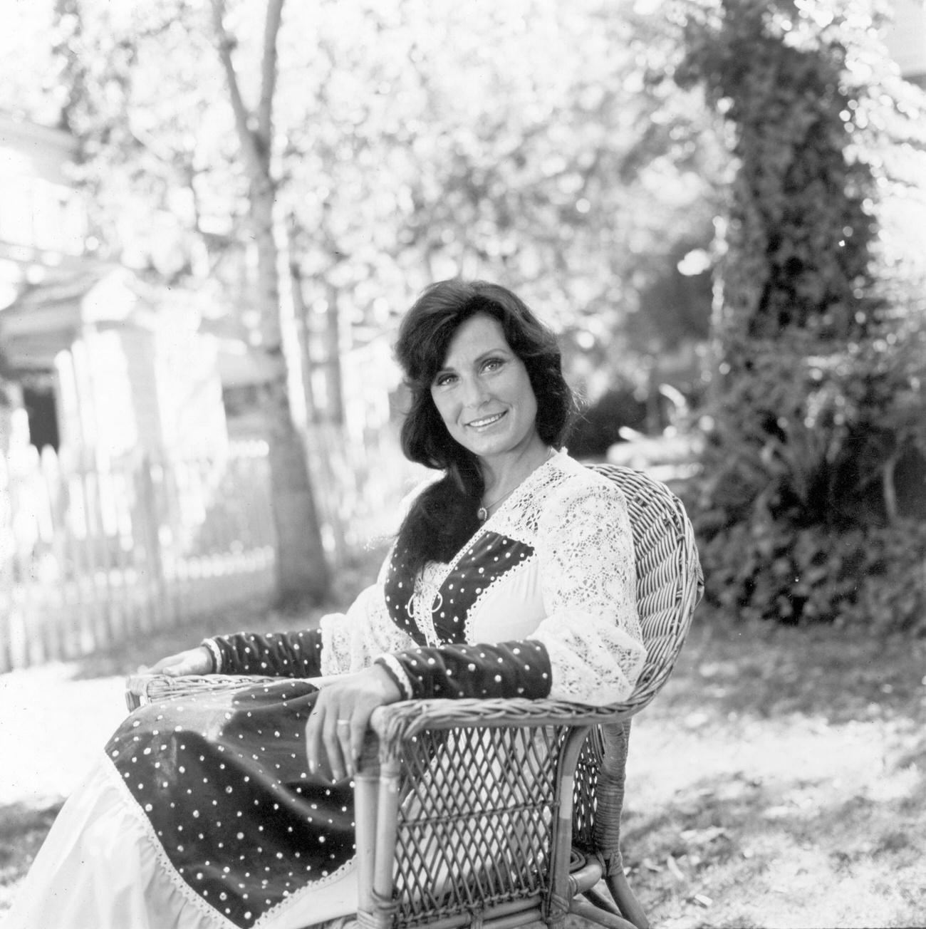 Loretta Lynn Seated Outdoors On A Lawn, 1978.