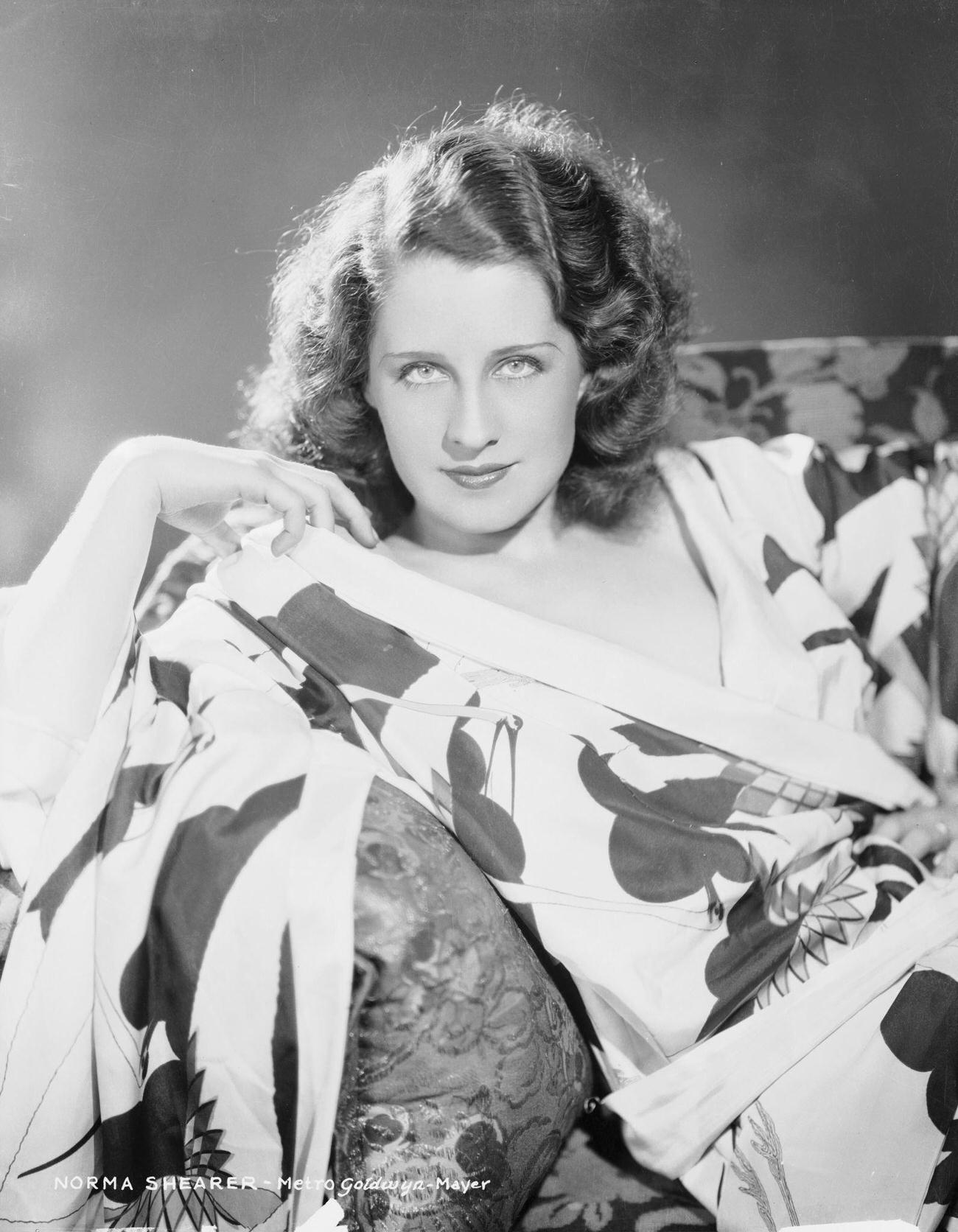 Norma Shearer Lounging On A Sofa In A Floral Patterned Dressing Gown, Circa 1928.