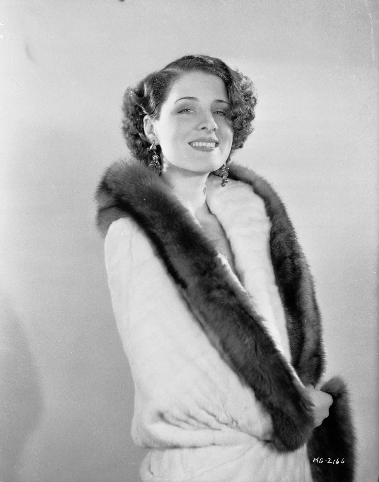 Norma Shearer Wearing A White Fur Coat With A Dark Trim, 1930.