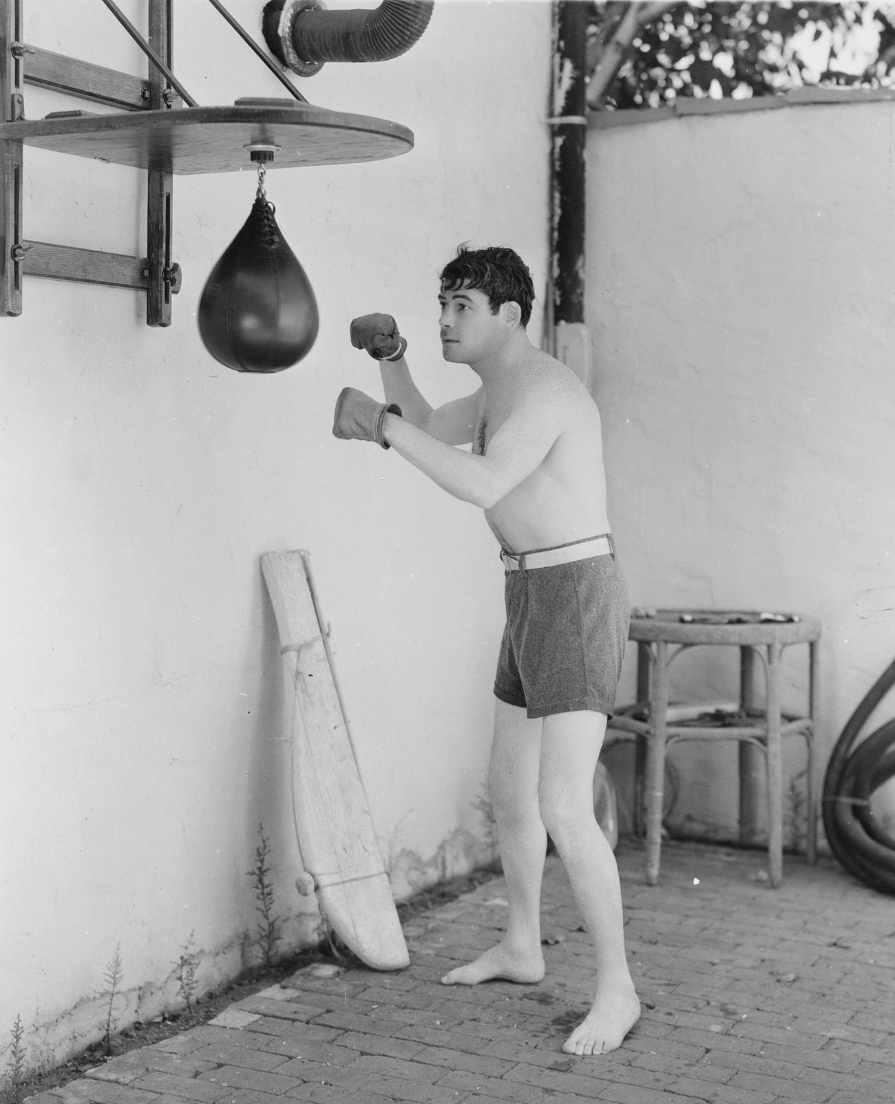 Paul Muni Working Out On A Punching Bag.
