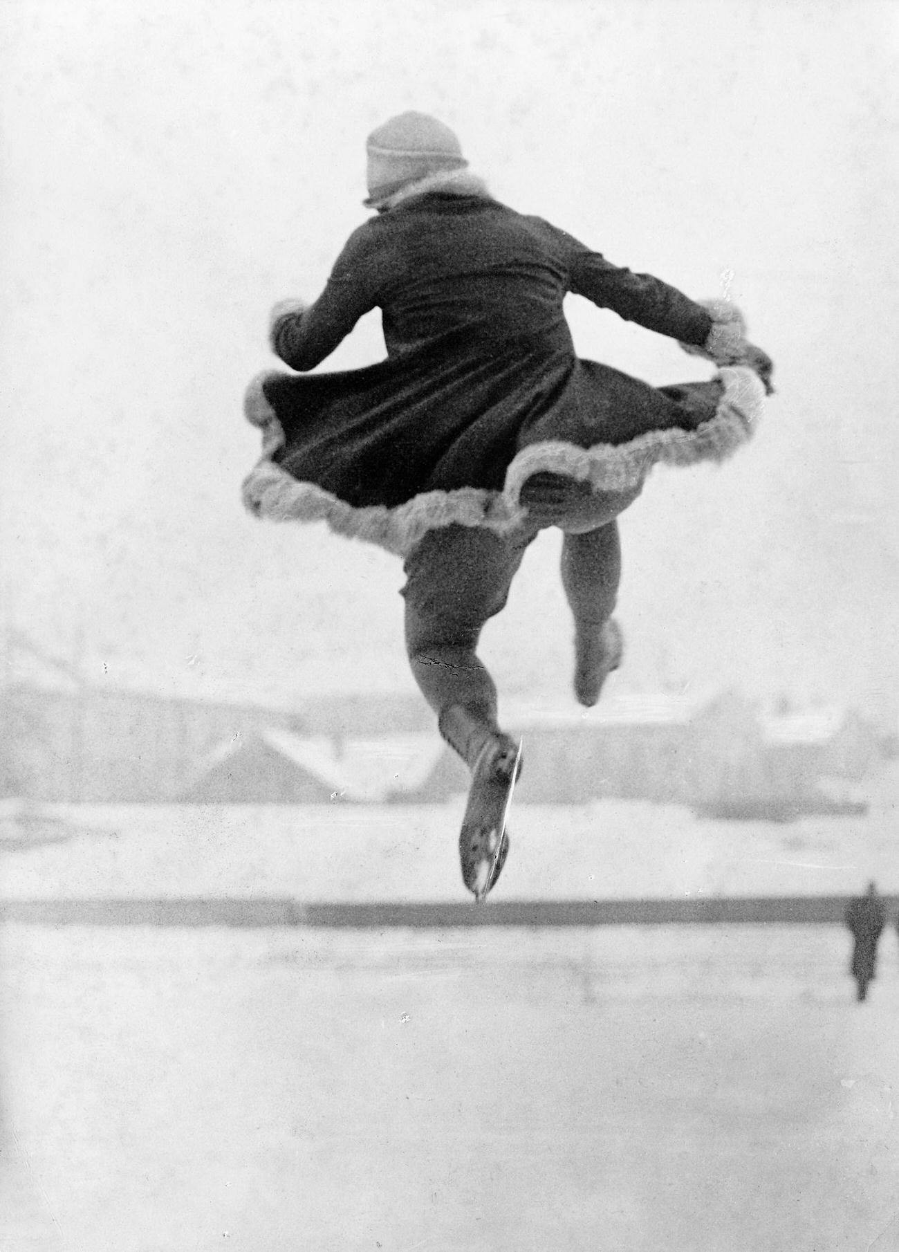 Sonja Henie Skating At St. Moritz, In Mid-Air, Back To The Camera.