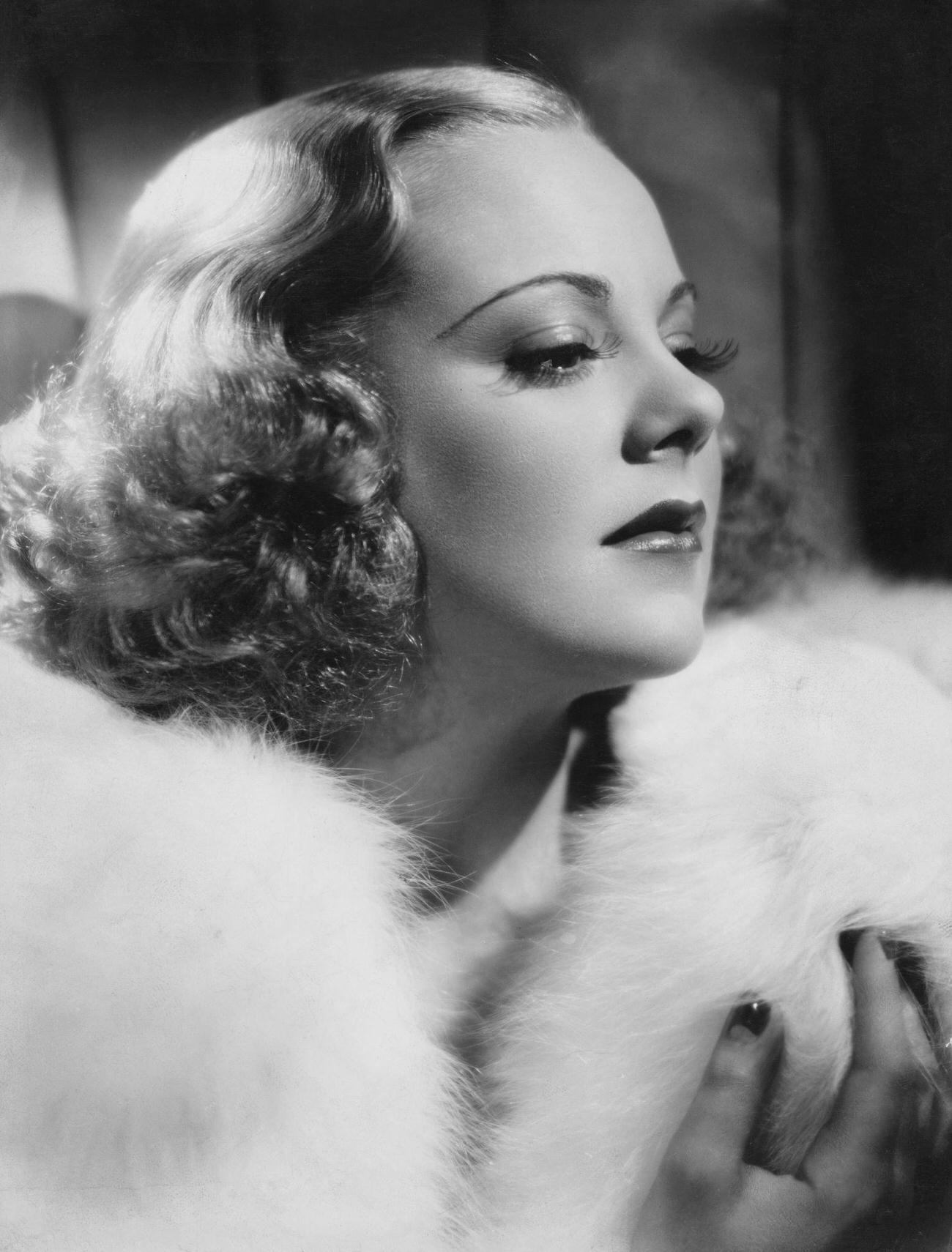 Sonja Henie Wearing A White Fur Coat In A Studio Portrait, Circa 1935.