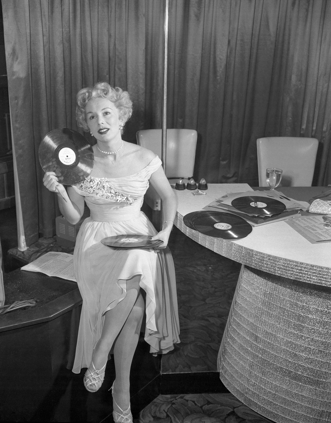 Eva Gabor Selecting Records For Her Midnight Disc Jockey Show.