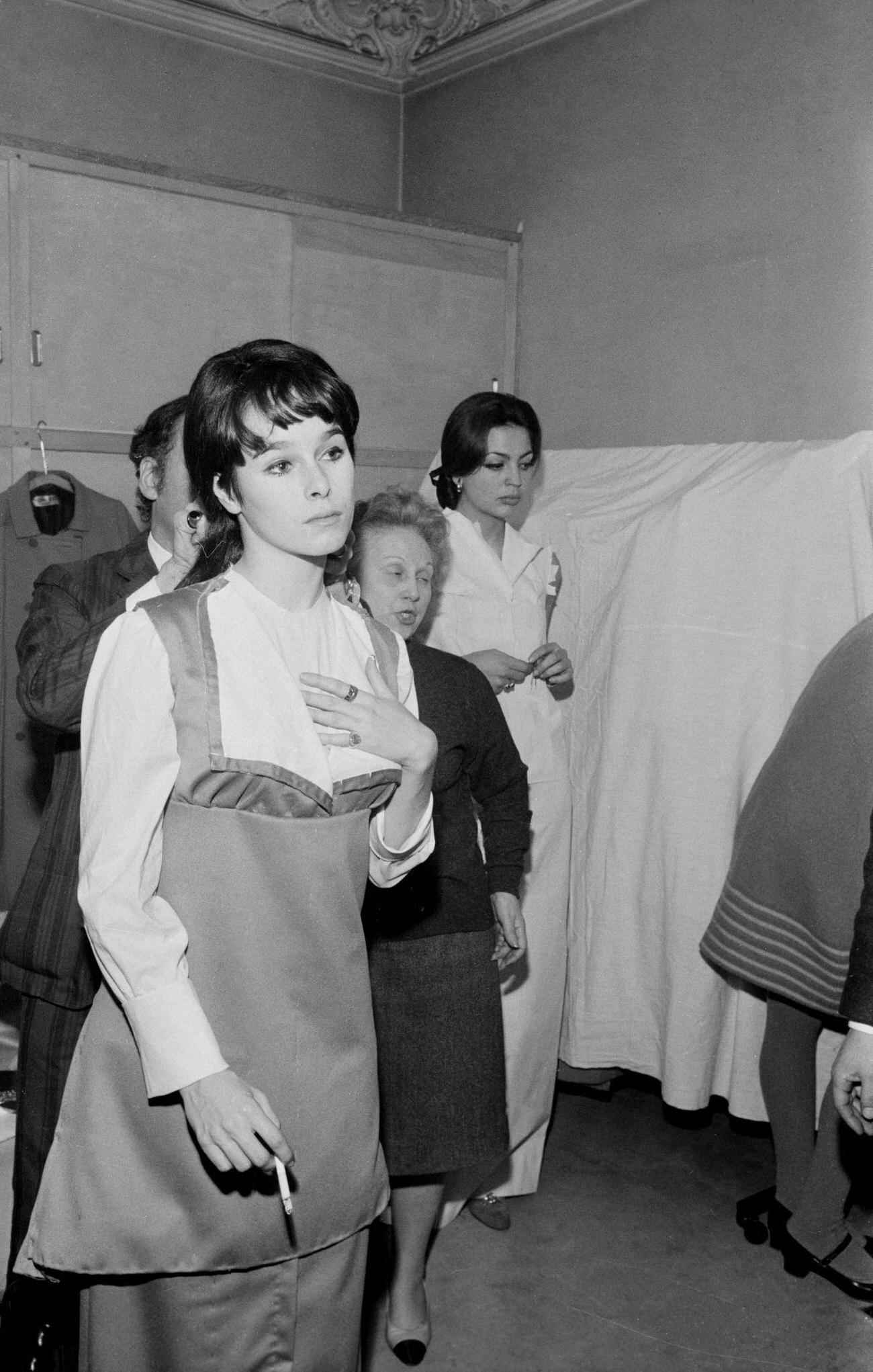 Geraldine Chaplin During A Fitting, With Princess Iea De Furstenberg In The Background, France, December 10, 1966.