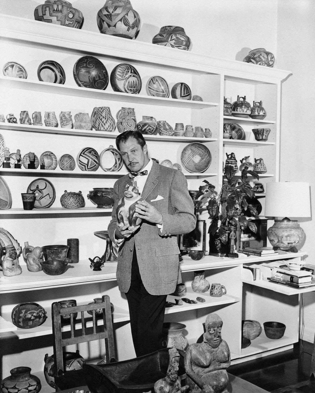 Vincent Price With A Display Of Ceramics From His Art Collection, Circa 1955.