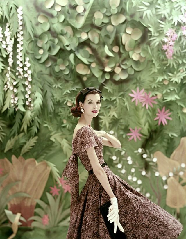 Joan Romano Wearing Galanos Silk Evening Dress In Brown Speckled Pattern And Wearing Black Satin Hair Bow And Diamond Earrings By Eisenberg, Photo By Richard Rutledge, Vogue, 1956