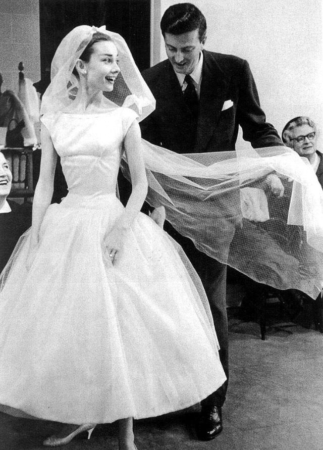 Hubert De Givenchy Photographed By David Seymour With His Muse Audrey Hepburn And Georgina (His Seamstress), During The Tests Of The Wedding Dress Created For “Funny Face” (1957), Paris (France), Spring Of 1956