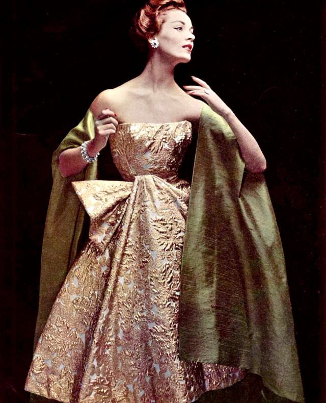 Model In Sumptious Gold Brocade Cocktail Dress Worn With Silk Shantung Cape-Stole By Jacques Heim, Jewelry By Roger Scémama, Photo By Philippe Pottier, 1956