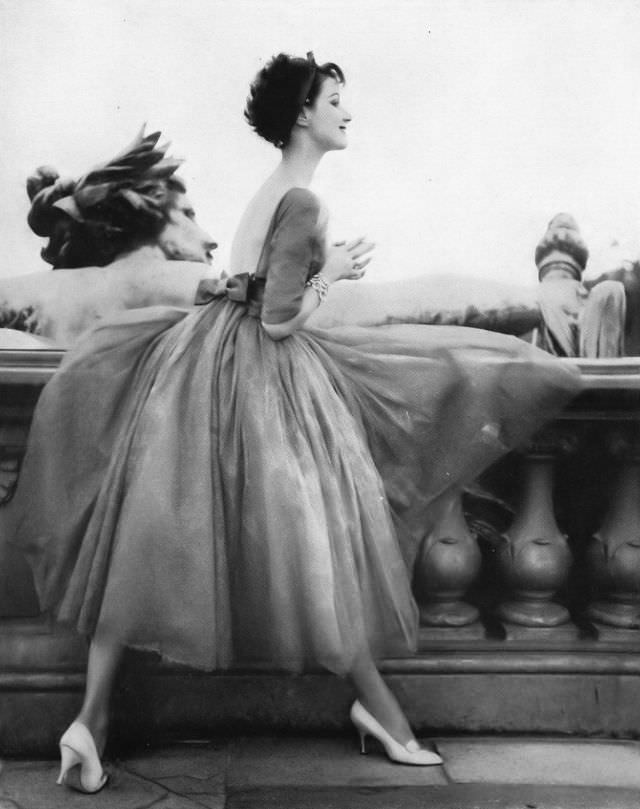 Betsy Pickering In Romantic Full Evening Dress Of Emerald-Green Lace Has Bodice That'S High In Front And Low In Back Tied With Wide Satin Ribbon By Jacques Heim, Photo By Roger Prigent, Vogue, November 15, 1957