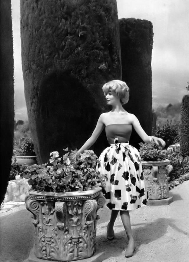 Simone D'Aillencourt In Red Bustier Worn With White Cotton Skirt Printed In Red, Blue And Green, By Jacques Heim, Photo By Philippe Pottier In Vence, France, 1958