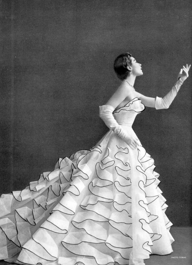 Bettina Graziani In Evening Gown Of White Ruffled Tulle Edged In Black By Jacques Heim, Photo By Herbert Tobias, 1953