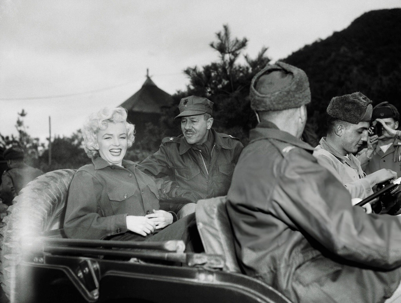 Marilyn Monroe Rides A Jeep With Brigadier General Robert Hobaboom, 1954.