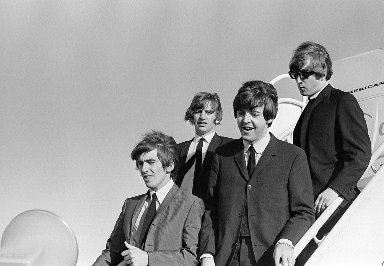 John Lennon, Paul Mccartney, Ringo Starr, And George Harrison Walking Down The Steps Of The Plane, 1964.