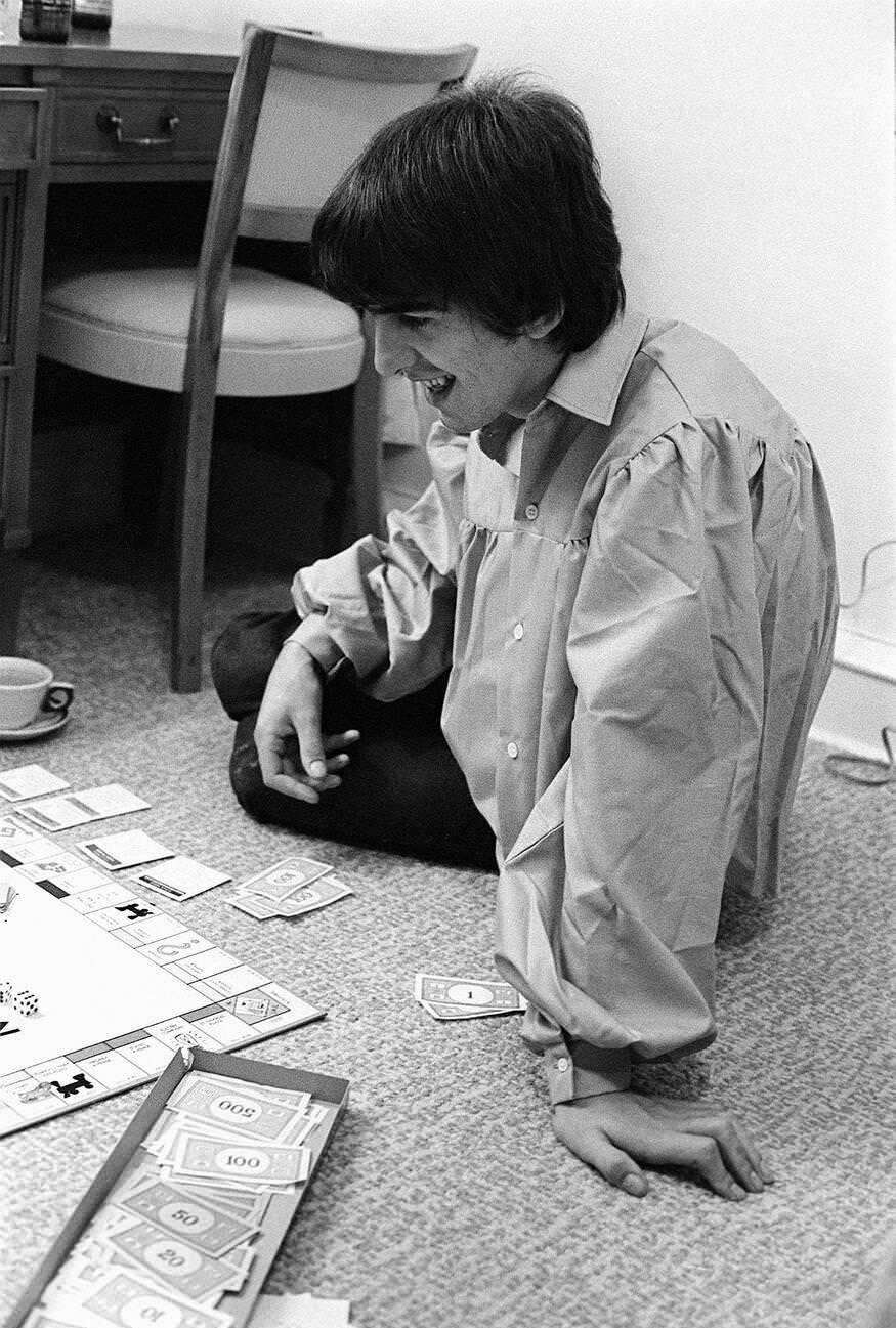 George Harrison Playing Monopoly At The Beatles Bel Air Home In California During The Tour, 1964.