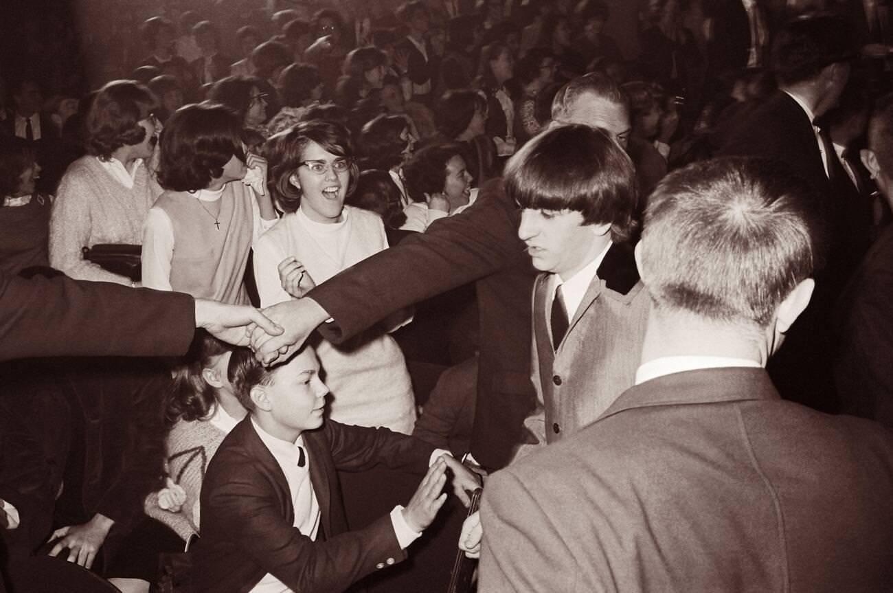 Police Join Hands To Hold Back Adoring Fans As Ringo Starr Walks By At The Washington Coliseum In Washington, D.c., Where The Beatles Were Performing In Their First American Concert, 1964.