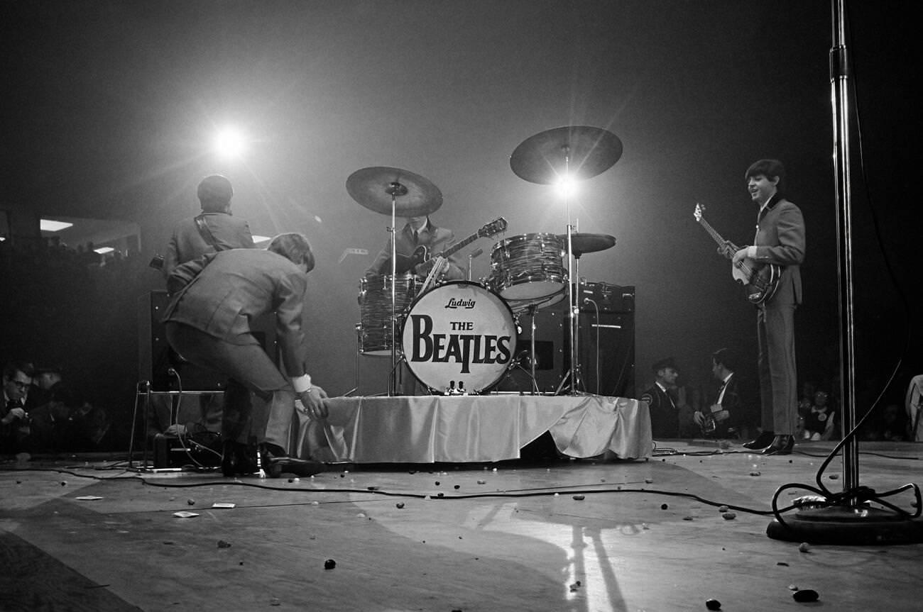 The Beatles Performing At The Washington Coliseum In Their First American Concert, 1964. The Stage Is Littered With Jelly Beans From Fans Pelting The Band With Them After A New York Newspaper Reported The Band Discussing A Like For Them.