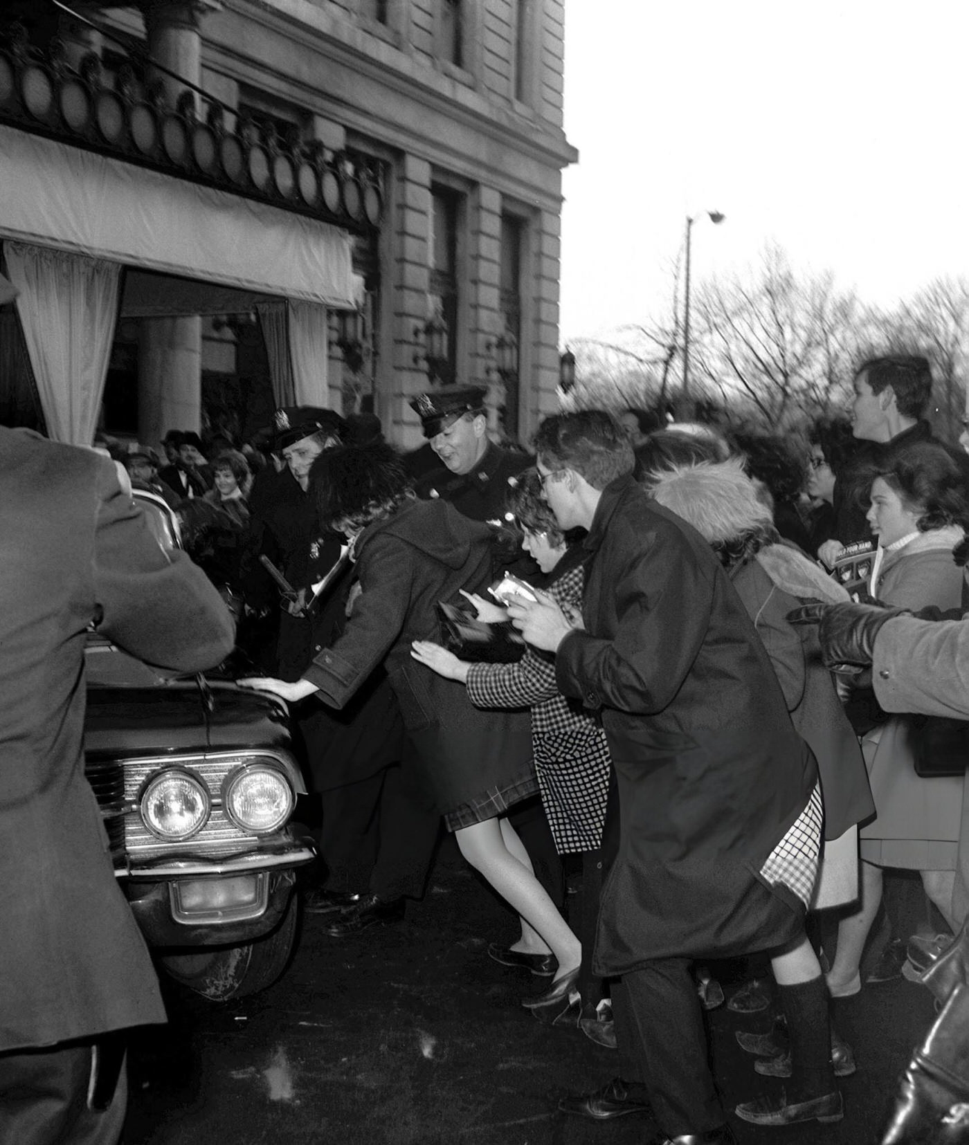 Chaos In The Streets Of New York As Police Try To Restrain Young American Music Fans Of British Pop Group The Beatles As They Await Their Idols During The Band'S Tour Of The States.