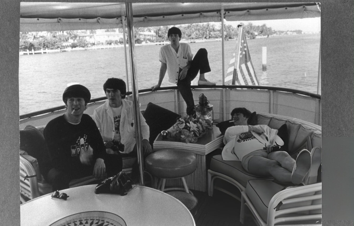 British Rock Group The Beatles Relax On A Boat Off The Coast Of Miami, Florida, 1964.