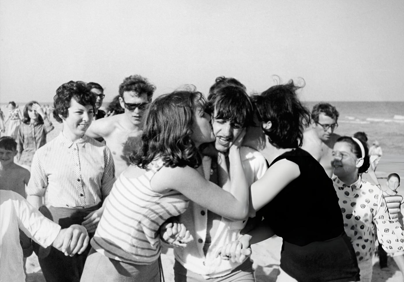 Drummer Ringo Starr Of The Beatles On A Beach In Miami, Florida, Getting Kissed By Female Fans, 1964.