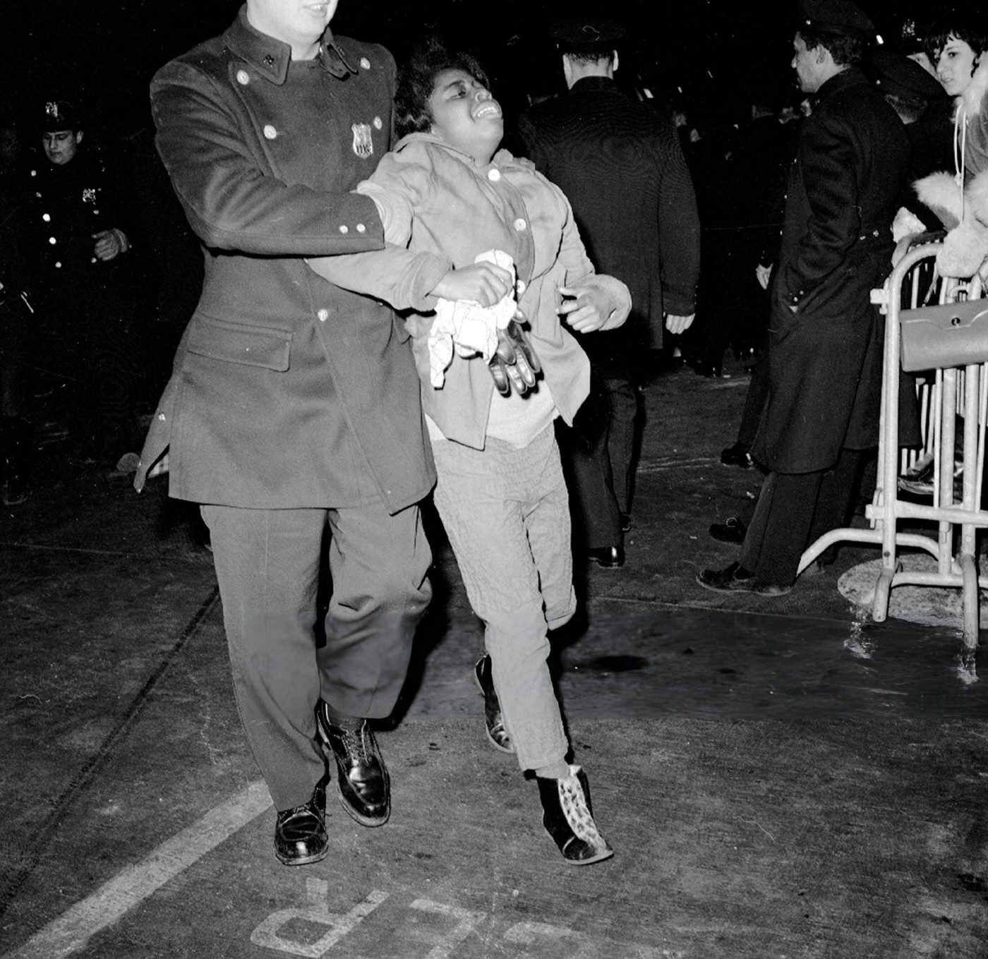 Beatles Fans Restrained By Police At Kennedy Airport, 1964.