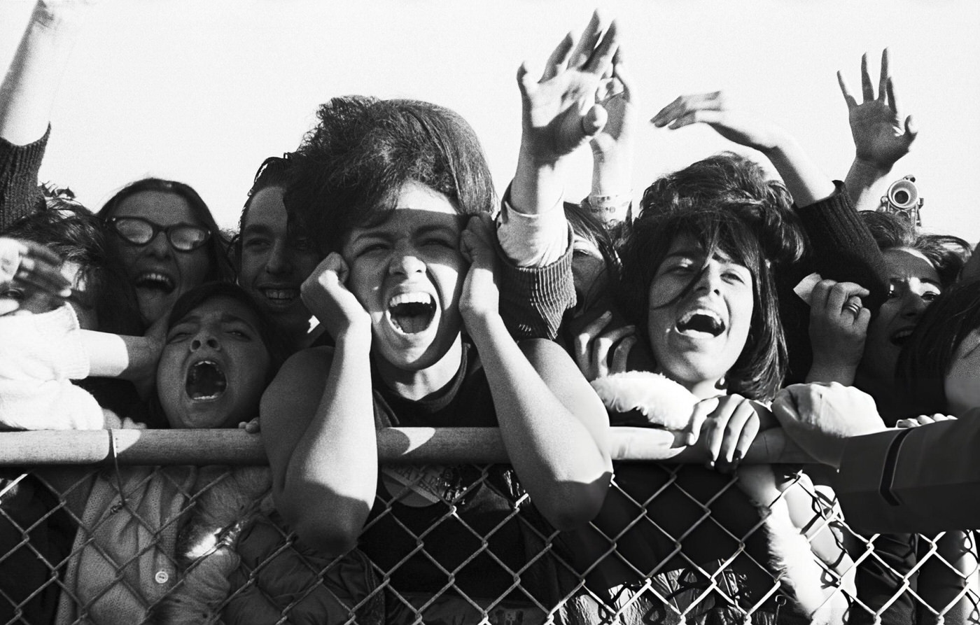 A Group Of Teenage Girls Scream With Excitement As They Greet The Beatles In San Francisco, California.