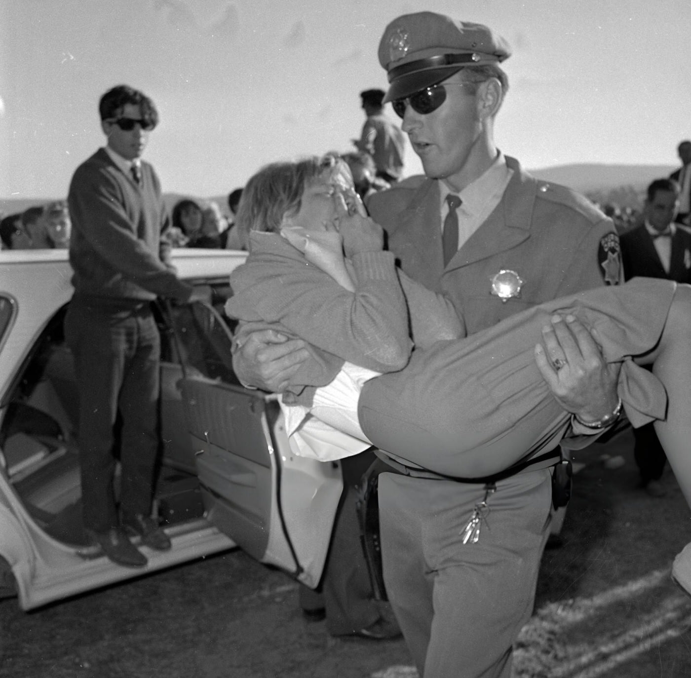 Police Try To Maintain Order As Crowds Of Fans Wait For The Beatles At San Francisco International Airport.