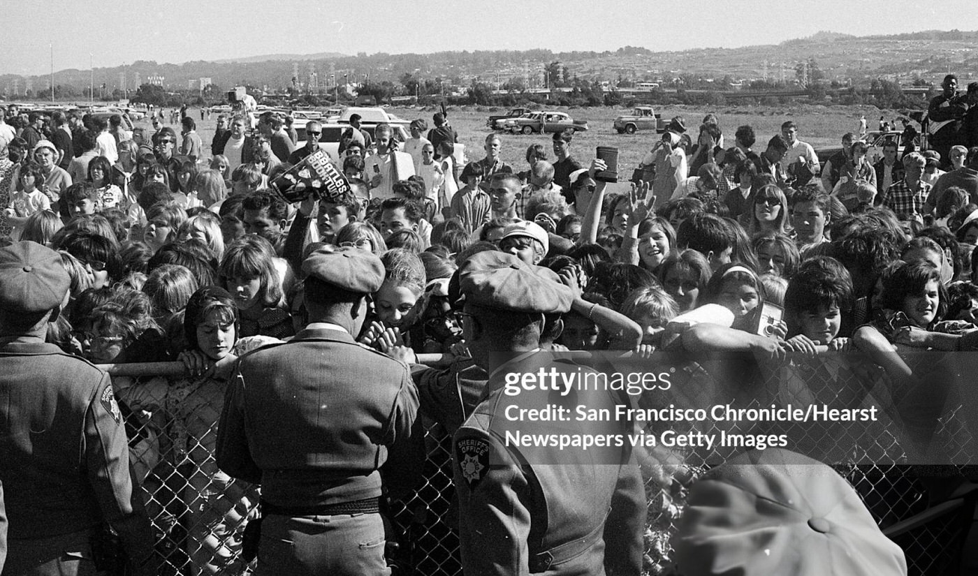 Police Try To Maintain Order As Crowds Of Fans Wait For The Beatles At San Francisco International Airport.