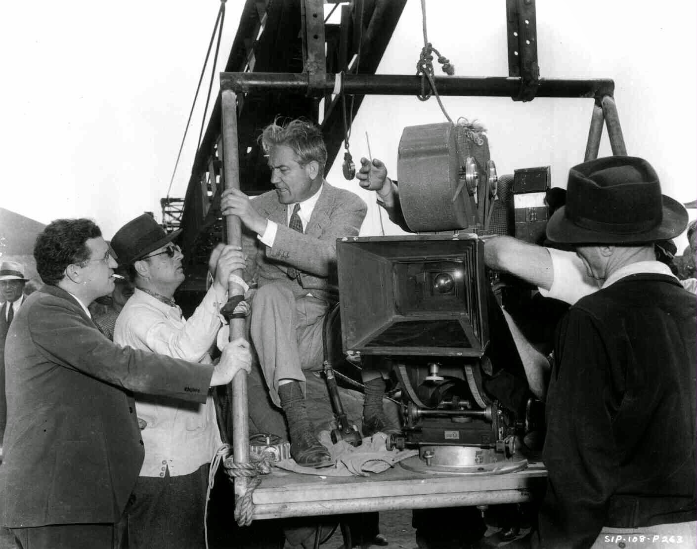 Director Victor Fleming Seated On Construction Crane, Mounted With A Camera. Producer David O. Selznick Stands Alongside With Technicians.
