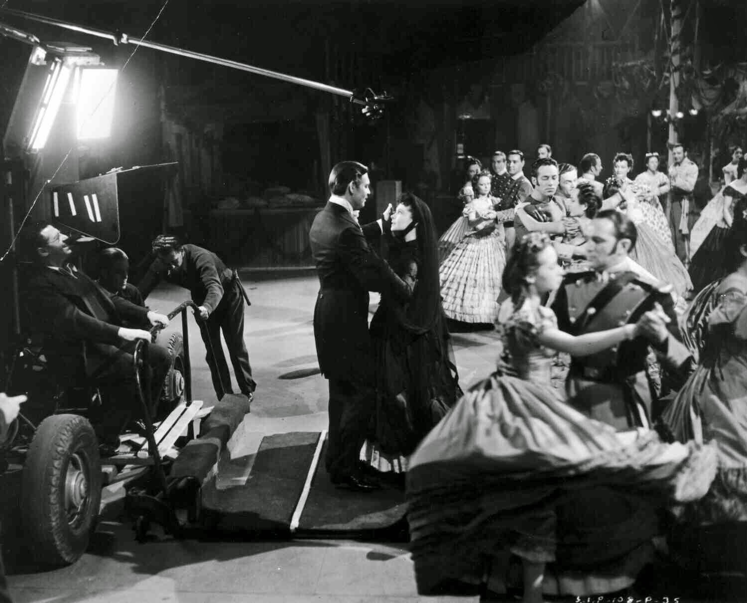 Clark Gable As Rhett Butler And Vivien Leigh, Dancing. Both Are Standing On A Movable Floor, Being Watched By Dancers And Director George Cukor, Before He Left Production.