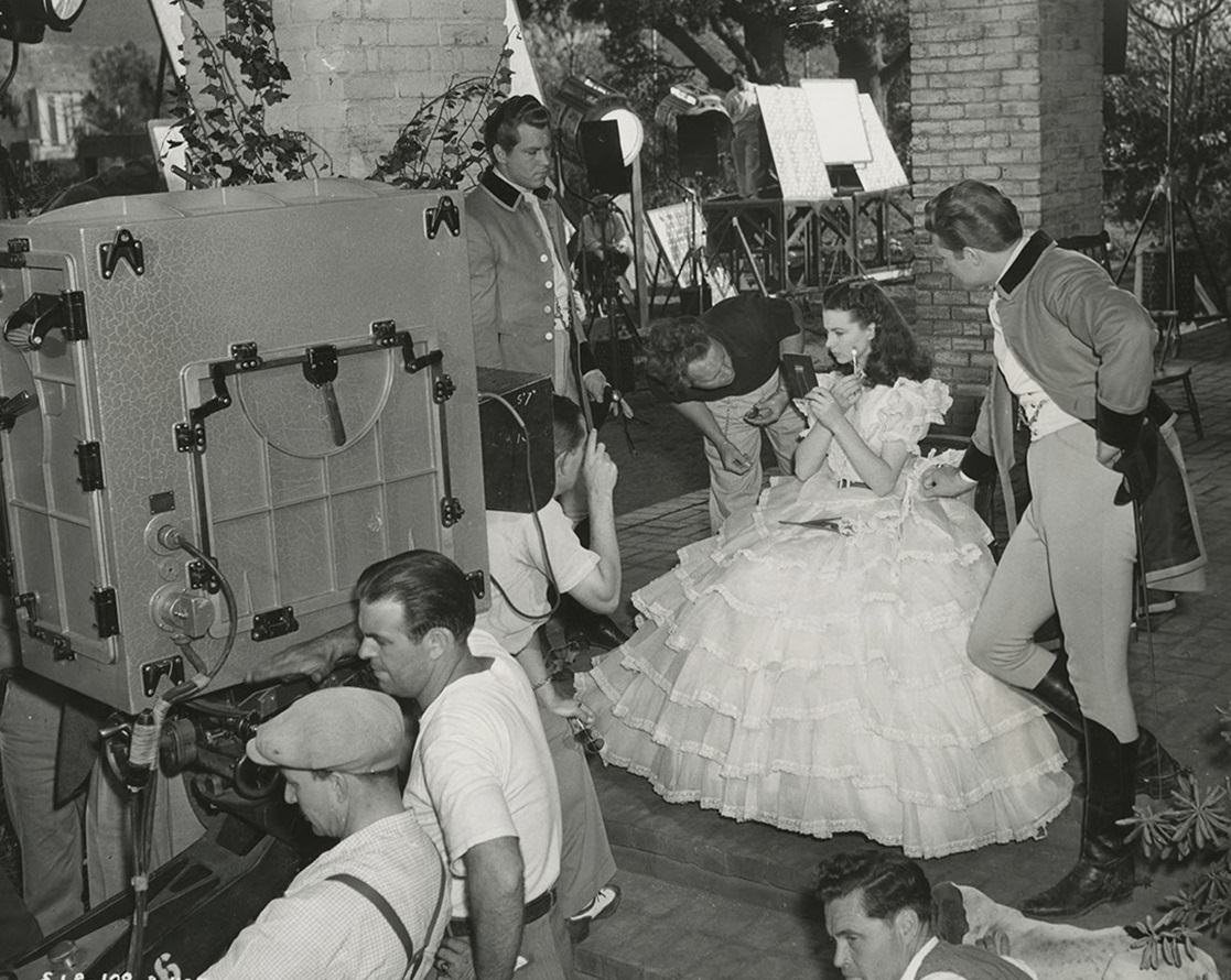 Vivien Leigh Touches Up Her Make Up As The Crew And Actors Fred Crane And George Reeves Prepare To Film The Final Version Of The Porch Scene.