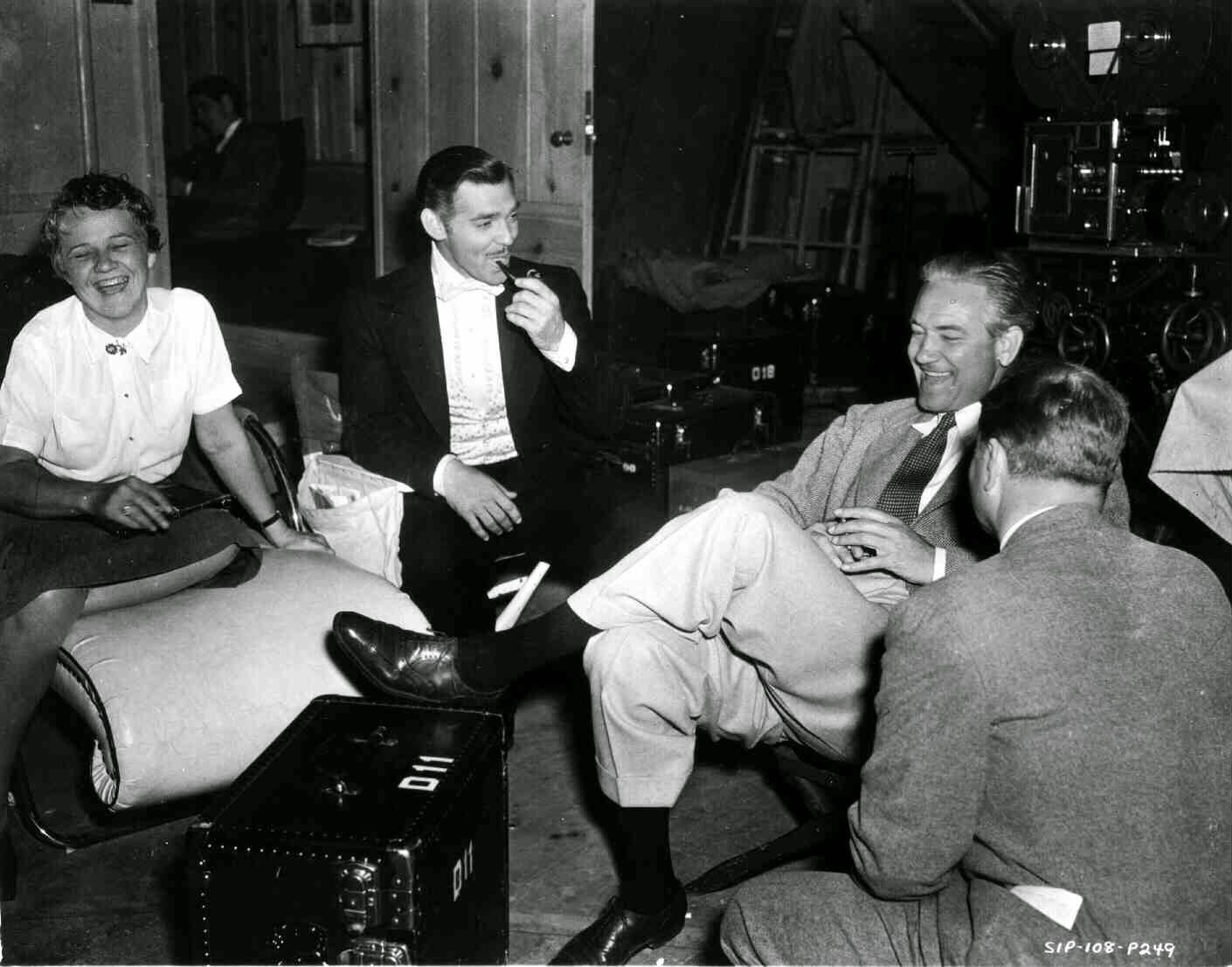 Susan Myrick, Technical Adviser, Clark Gable As Rhett Butler, Smoking Pipe, Director Victor Fleming, All Seated And Laughing.