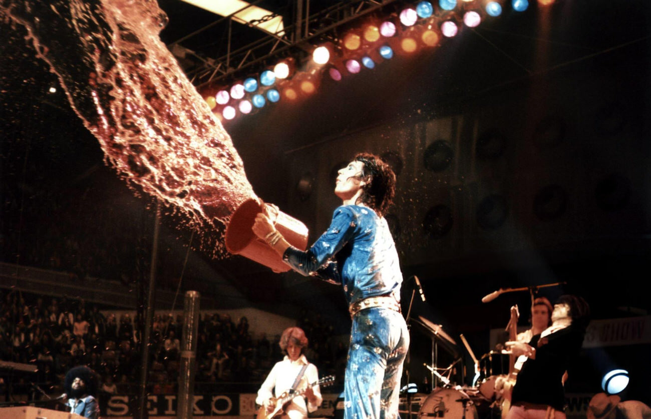 Mick Jagger Throwing Water At The Crowd During A Rolling Stones Concert On Their 1973 European Tour.