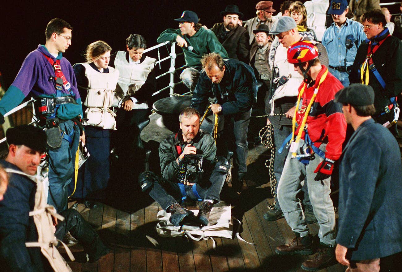 Cameron Surrounded By Cast And Crew Members, Filming A Scene For Titanic