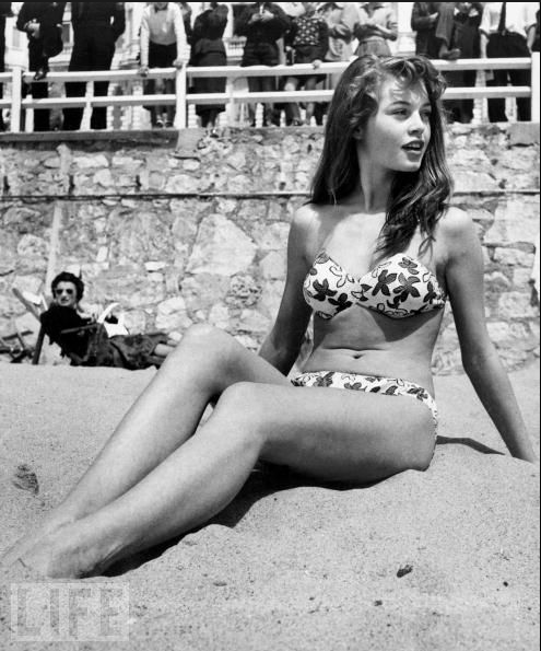 French Actress Brigitte Bardot Sits On The Beach During The Cannes Film Festival, 1953.