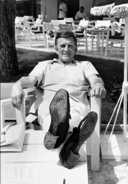 Kirk Douglas Lets His Feet Do The Talking At Cannes, 1966.