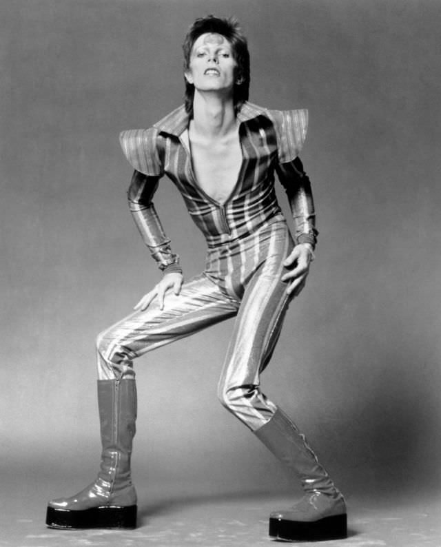 In A Striped Jumpsuit And Platform Boots Posing As Ziggy Stardust In London, 1972.