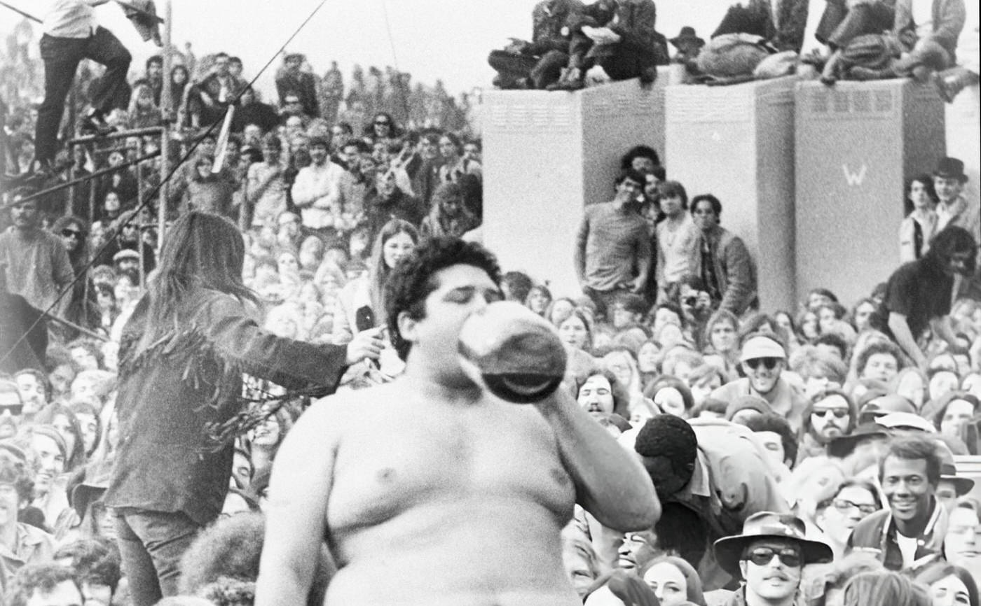 Man Drinking From A Bottle At The Altamont Free Concert, 1969.