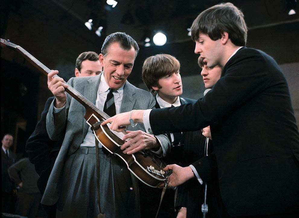 Paul Mccartney Shows His Guitar To Ed Sullivan Before The Beatles' Live Television Appearance In New York, February 9, 1964; Also Shown Are Beatles Manager Brian Epstein, John Lennon, And Ringo Starr.