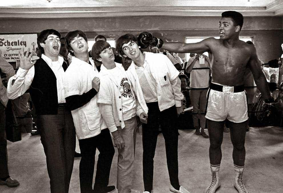 The Beatles Take A Fake Blow From Cassius Clay, Who Later Changed His Name To Muhammad Ali, While Visiting The Heavyweight Contender At His Training Camp In Miami Beach, Florida, February 18, 1964.