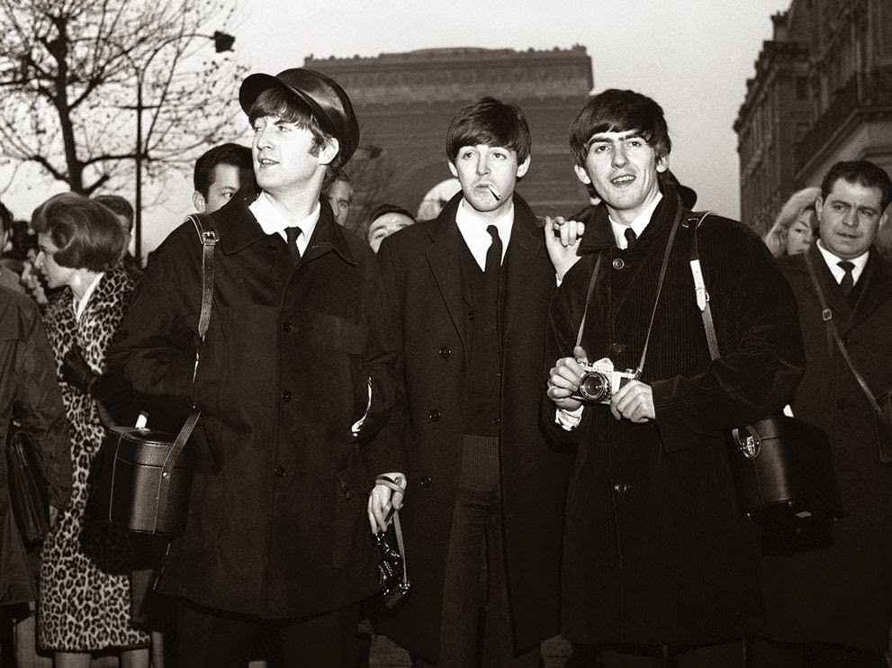 The Beatles Sightseeing In Paris On The Champs Elysees, With The Arc De Triomphe In The Background, January 15, 1964, The Day Before Their Opening At The Olympia Theatre In Paris.