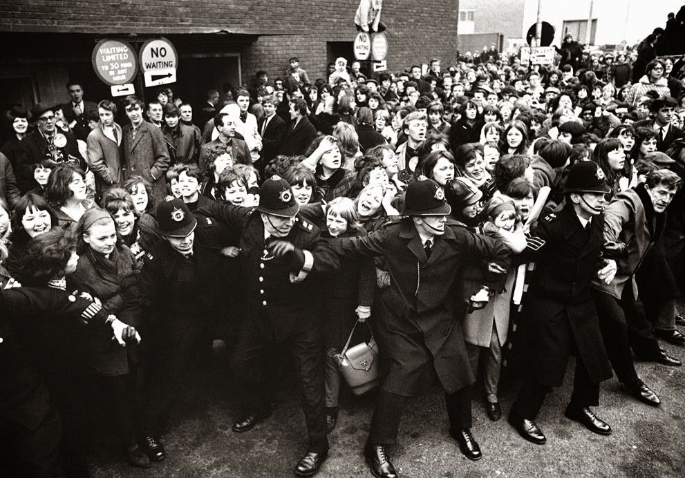 Policemen Control Screaming Beatles Fans As The Liverpool Pop Group Was Welcomed By A Group Of More Than 5,000 On Their Arrival At London Airport On Their Return From America, February 22, 1964.