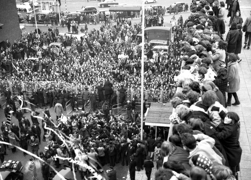 The Beatles Are Surrounded By Newsmen And Press Photographers And Overlooked By Hundreds Of Fans After Their Arrival At London Airport, England, Having Flown In From New York, February 22, 1964.