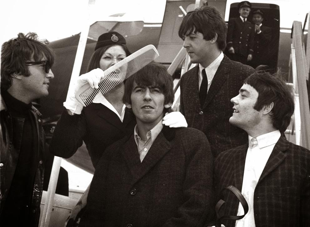 George Harrison Gets The Big Comb Treatment From Boac Stewardess Anne Creech, After The Beatles' Arrival At Windy Airport In London, England, June 7, 1964; Also Shown Are John Lennon, Paul Mccartney, And Jimmy Nicol, Who Stood In For Ringo Starr For The Trip To The Netherlands.