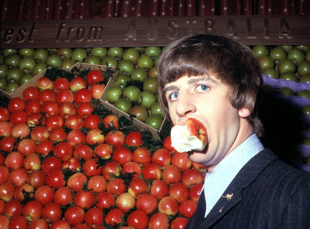 Ringo Starr Samples An Apple During A Visit To Australia House In London, England, 1964.