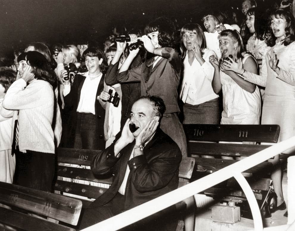 A Man Covers His Ears As 18,000 Screaming Fans React To The Beatles In The Hollywood Bowl, California, During Their U.s. Concert Tour, August 23, 1964.
